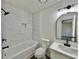 This modern bathroom features white marble-style tile, updated fixtures, and a sleek vanity at 101 Summer Pond Trl, Lawrenceville, GA 30046