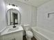 This bathroom features a tub with modern tile, updated lighting fixtures, and a black faucet at 101 Summer Pond Trl, Lawrenceville, GA 30046