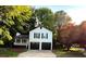 Inviting two-story home featuring a covered front porch, two car garage, and a spacious driveway at 101 Summer Pond Trl, Lawrenceville, GA 30046