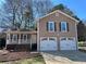 Charming home featuring a two-car garage, covered porch, and neutral-toned siding at 101 Summer Pond Trl, Lawrenceville, GA 30046