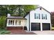 Charming two-story home with a two-car garage and white siding, nestled among mature trees at 101 Summer Pond Trl, Lawrenceville, GA 30046