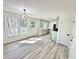 This spacious kitchen has light green cabinets, stainless appliances, and backyard views at 101 Summer Pond Trl, Lawrenceville, GA 30046