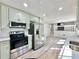 Charming kitchen features stainless steel appliances, light green cabinets and bright white countertop at 101 Summer Pond Trl, Lawrenceville, GA 30046