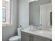 Modern bathroom featuring marble countertop, sleek gray cabinets, and a window providing natural light at 1226 Chelsea Nw Cir, Atlanta, GA 30318