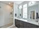 Well-lit bathroom with a glass-enclosed shower, a large mirror, and double vanity at 1226 Chelsea Nw Cir, Atlanta, GA 30318