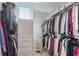 Walk-in closet with ample storage space, including built-in shelving and rods for hanging clothes at 1226 Chelsea Nw Cir, Atlanta, GA 30318