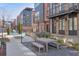 Charming community space with a rustic wooden picnic table and landscaped stone area between the modern brick buildings at 1226 Chelsea Nw Cir, Atlanta, GA 30318