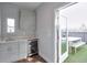 Small kitchenette featuring a sink, cabinets, wine fridge, and access to a rooftop patio at 1226 Chelsea Nw Cir, Atlanta, GA 30318