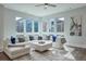 Bright living room features large windows, hardwood floors, a ceiling fan, and a comfortable sectional sofa at 1226 Chelsea Nw Cir, Atlanta, GA 30318