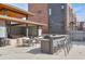 Inviting outdoor kitchen area with granite countertop bar, grill, sink, and dining table at 1226 Chelsea Nw Cir, Atlanta, GA 30318