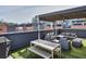 Inviting rooftop patio with lounge seating, a dining table, and artificial turf, creating an urban outdoor oasis at 1226 Chelsea Nw Cir, Atlanta, GA 30318