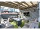 An outdoor space with comfortable seating around a coffee table, greenery, and a mounted television at 1226 Chelsea Nw Cir, Atlanta, GA 30318