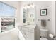 Bathroom with a modern sink, white cabinets, and a large window at 2353 Medlock Ln, Decatur, GA 30033