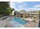 Relaxing community pool area featuring plenty of lounge chairs and a covered seating area for residents at 2353 Medlock Ln, Decatur, GA 30033