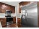 Kitchen with stainless steel appliances, dark wood cabinets, and stone countertops at 3619 Ponderosa Ln, Powder Springs, GA 30127