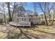 Rear exterior view of home with back deck and green yard at 1743 Thomas Ter, Decatur, GA 30032