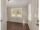 Cozy bedroom featuring wood-look flooring, neutral paint, and abundant natural light from the windows at 1743 Thomas Ter, Decatur, GA 30032