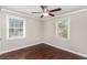 Bedroom with ceiling fan, hardwood floor, white trim, and dual windows at 1743 Thomas Ter, Decatur, GA 30032
