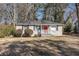 Charming single-story home with a red door, a landscaped yard, and traditional curb appeal at 1743 Thomas Ter, Decatur, GA 30032