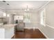 Eat-in kitchen featuring a stainless steel refrigerator, granite island, and natural light with hardwood floors at 1743 Thomas Ter, Decatur, GA 30032