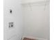 White laundry room with hookups and wire shelving at 1743 Thomas Ter, Decatur, GA 30032