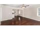 Open living room showcasing hardwood floors and neutral paint, flowing seamlessly into the kitchen and dining area at 1743 Thomas Ter, Decatur, GA 30032