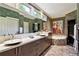 Well-appointed bathroom featuring double vanity, marble countertop, soaking tub, and tiled floors at 857 Stovall Ne Pl, Atlanta, GA 30342