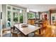 Bright dining space adjacent to kitchen features hardwood flooring and access to the backyard at 857 Stovall Ne Pl, Atlanta, GA 30342