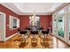 Dining room features hardwood floors, a modern chandelier, and large windows for ample natural light at 857 Stovall Ne Pl, Atlanta, GA 30342