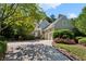 Beautiful home exterior featuring a well-manicured lawn, mature trees, and an attached two-car garage at 857 Stovall Ne Pl, Atlanta, GA 30342