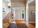 Open foyer with hardwood floors, a staircase, and natural light streaming in through the front door at 857 Stovall Ne Pl, Atlanta, GA 30342