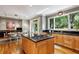 Kitchen with stainless steel appliances and island with stovetop, adjacent to a breakfast nook at 857 Stovall Ne Pl, Atlanta, GA 30342