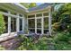 Screened patio with outdoor dining set, surrounded by mature trees and landscaping, offering a private escape at 857 Stovall Ne Pl, Atlanta, GA 30342