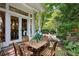 Outdoor patio with brick paving, wooden furniture, and framed by beautiful landscaping for relaxing moments at 857 Stovall Ne Pl, Atlanta, GA 30342