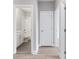 View into a bathroom with a white vanity and subway tile shower from a hallway with hardwood floors at 1330 Parc Bench Rd, Atlanta, GA 30316