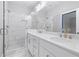 A luxurious bathroom with white countertops and tiling, gold hardware and a glass-enclosed shower at 1330 Parc Bench Rd, Atlanta, GA 30316