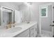 A well-lit bathroom with white countertops, gold hardware and a glass-enclosed shower at 1330 Parc Bench Rd, Atlanta, GA 30316