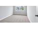 A bright bedroom with neutral carpet, light gray walls and a window showing the exterior of another home at 1330 Parc Bench Rd, Atlanta, GA 30316