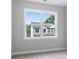 Bright bedroom with a large window looking out onto a backyard and neutral paint and carpet at 1330 Parc Bench Rd, Atlanta, GA 30316
