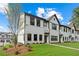 Charming new construction townhome with brick and siding exterior, green lawn and beautiful landscaping at 1330 Parc Bench Rd, Atlanta, GA 30316