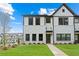 Attractive new townhome with white brick and siding exterior, green lawn, and convenient front sidewalk at 1330 Parc Bench Rd, Atlanta, GA 30316