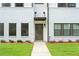 Close-up of the front door on a new townhome with white brick, dark trim, and a well-manicured lawn at 1330 Parc Bench Rd, Atlanta, GA 30316