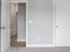 A neutral-colored hallway featuring white doors with an entryway leading to a room with light hardwood flooring at 1330 Parc Bench Rd, Atlanta, GA 30316