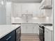 A modern kitchen featuring white cabinets, quartz countertops and stainless steel appliances at 1330 Parc Bench Rd, Atlanta, GA 30316