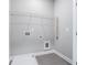 A laundry room with gray tile floors, a white utility sink and wire shelving at 1330 Parc Bench Rd, Atlanta, GA 30316