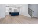Spacious living room with open layout, hardwood floors, leading to the kitchen with island and staircase at 1330 Parc Bench Rd, Atlanta, GA 30316