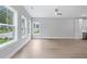 Open living area with hardwood floors, large windows, and views of the modern kitchen with stainless appliances at 1330 Parc Bench Rd, Atlanta, GA 30316