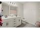 Bright bathroom features double vanity, modern fixtures, and a shower with a patterned curtain at 1590 Branthaven Ln, Auburn, GA 30011