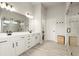 Bright bathroom features a double vanity with modern fixtures and a glass-enclosed shower at 1590 Branthaven Ln, Auburn, GA 30011