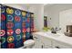 Bathroom with superhero-themed shower curtain, modern vanity, and neutral-toned walls at 1590 Branthaven Ln, Auburn, GA 30011